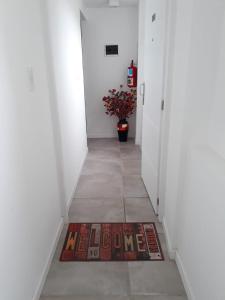 a hallway with a welcome mat on the floor at Departamentos Paradise in Río Grande