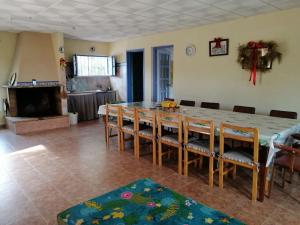 a dining room with a long table and chairs at Cortijo El Pericón in La Aljorra