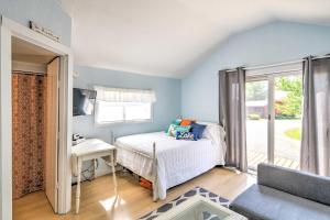 a bedroom with a bed and a couch and a window at Tiny House Cottage 6 with Dock on Crooked Lake in Oden