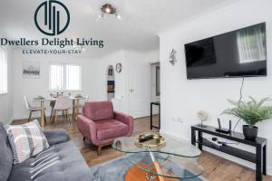a living room with a couch and a table at Dwellers Delight Living Ltd Serviced Accommodation Charming 3 Bedroom Flat, Chafford Hundred, Grays with Free Parking & Wifi in West Thurrock
