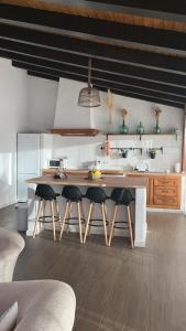 a kitchen with a large wooden table and chairs at Apartamentos Rurales En Plena Sierra in La Calera