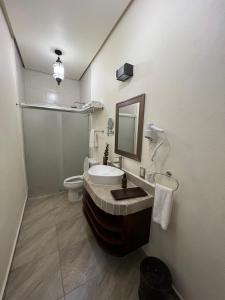 a bathroom with a tub and a toilet and a sink at Hotel Boutique Rincón de Luna in San Juan del Río