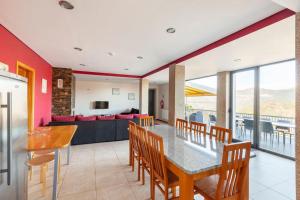 a kitchen and dining room with a table and chairs at Casa de Balinhas - Gerês in Cova