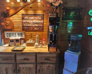 a coffee shop with a counter with a coffee bar at Outdoorsman Motel in Wawa