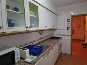 a kitchen with a sink and a counter top at Mar Salgado Apartment in Armação de Pêra