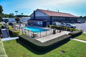 a building with a swimming pool in a yard at Americas Best Value Inn Douglasville in Douglasville