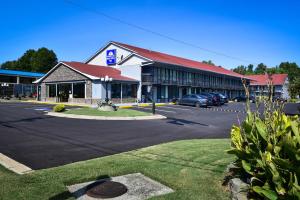 a large building with a parking lot in front of it at Americas Best Value Inn Douglasville in Douglasville