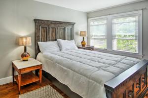 a bedroom with a large bed and two lamps on tables at Large Maine Home - 5 Min Walk to Old Orchard Beach in Old Orchard Beach