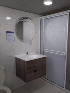 a bathroom with a sink and a mirror at Casa turística Erikmar in Gaira