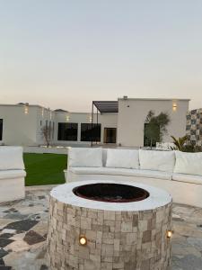a living room with a couch and a fire pit at Seagemfuj in Fujairah