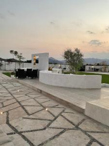 a patio with a table and chairs in a building at Seagemfuj in Fujairah