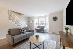 a living room with a couch and a table at Modern Stunning SouthPark/Cotswold Home! in Charlotte