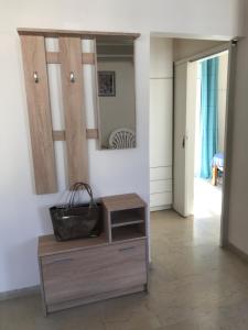 a room with a dresser and a mirror on a wall at Loutraki Vacation in Loutraki