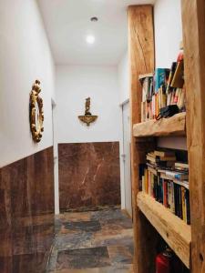 a hallway with a book shelf filled with books at XuBa ApartmentRooms I Wien Messe Prater I Küchenzeile in Vienna