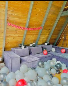 a room filled with balloons and a purple couch at Özlifesapanca Bungalow in Sapanca