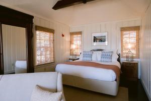 a bedroom with a large bed and two windows at Nick's Cove in Marshall