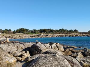 a group of rocks on the shore of a body of water at tourmaline in Concarneau