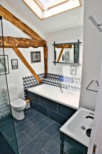 a bathroom with a tub and a toilet and a sink at Les Picardies in Lesterps