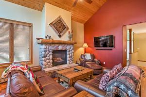 a living room with a couch and a fireplace at Steamboat Springs Townhome 1 Block to Ski Lifts! in Steamboat Springs