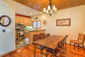 a kitchen and dining room with a wooden table and chairs at Steamboat Springs Townhome 1 Block to Ski Lifts! in Steamboat Springs