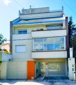 a building with two garage doors in front of it at Ayres de Saavedra - Dot Baires Shopping in Buenos Aires