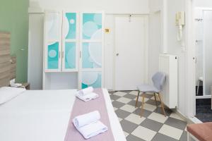 a bedroom with a bed and a chair at Klonos Anna in Egina