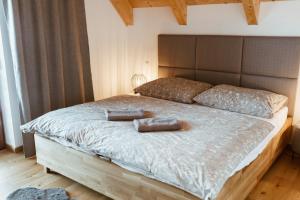 a bedroom with a bed with two pillows on it at Villa Štít Stará Lesná in Stará Lesná