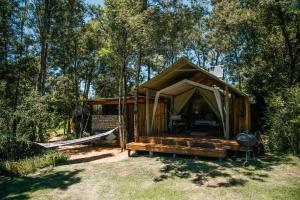 a tent with a hammock and a grill at HighlandsView in Swellendam