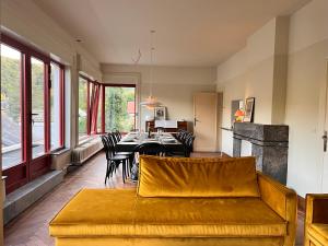 a living room with a couch and a table at Villa Michaux in Hastière-par-delà