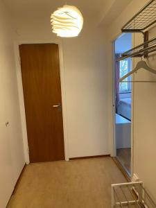 an empty room with a door and a window at A charming central one room apartment. in Malmö