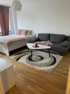 a living room with a couch and a coffee table at A charming central one room apartment. in Malmö