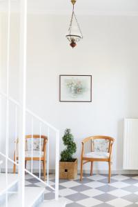 a room with two chairs and a potted plant at Klonos Anna in Egina