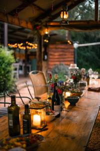 a long wooden table with bottles of wine and candles at HighlandsView in Swellendam