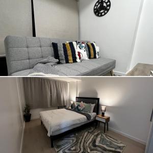 a living room with a bed and a clock on the wall at Haldis Suites in San Fernando