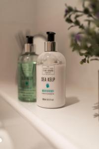 two bottles of sea kelp sitting on a shelf at West End Escape - Prime Location in Glasgow