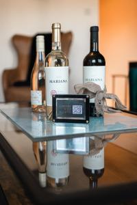 three bottles of wine sitting on a glass table at West End Escape - Prime Location in Glasgow +17 photos