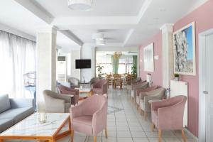 uma sala de espera com cadeiras, uma mesa e um sofá em Klonos Anna em Aegina Town