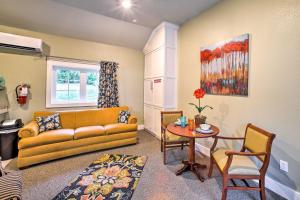 a living room with a couch and a table at Welcoming Downtown Branson Cottage with Pool Access! in Branson