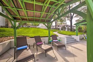 a group of chairs sitting under a gazebo at Welcoming Downtown Branson Cottage with Pool Access! in Branson