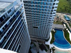 an aerial view of a tall building with a swimming pool at Haldis Suites in San Fernando