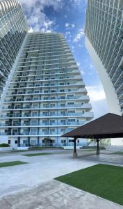 a large building with a pavilion in front of it at Haldis Suites in San Fernando