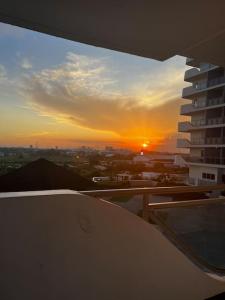 a view of a sunset from the balcony of a building at Haldis Suites in San Fernando