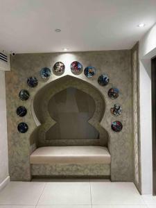 a room with blue and white plates on a wall at Haldis Suites in San Fernando