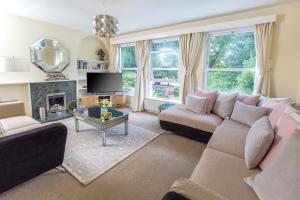 a living room with a couch and a fireplace at Glensanda - By Luxury Apartments in Cheltenham
