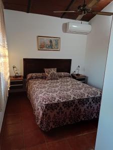 a bedroom with a bed and two night stands at Casa José in Ardales