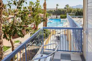 a balcony with a view of a pool at Klonos Anna in Egina