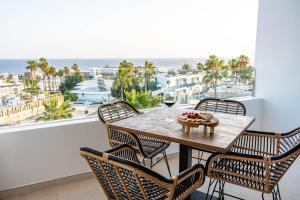 a dining room with a table with a view of the ocean at KALIMA APARTMENT in Puerto del Carmen