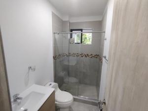 a bathroom with a shower and a toilet and a sink at CASA CAMPESTRE VILLALUPO in Villavicencio