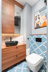 a bathroom with a sink and a toilet at Apartament Plac Konstytucji by Your Freedom in Warsaw