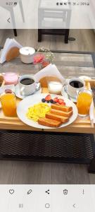 a tray with a plate of breakfast food on a table at COSMOPOLITAN INN in Ventanilla